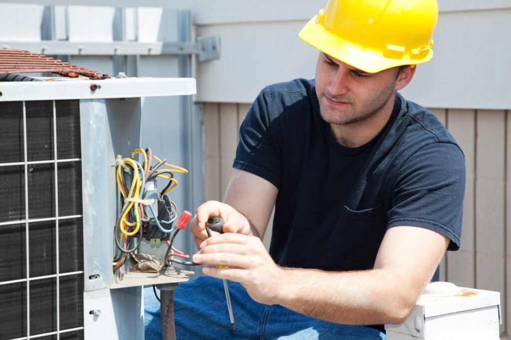 Dearing compressor employee working on a rotary screw air compressor