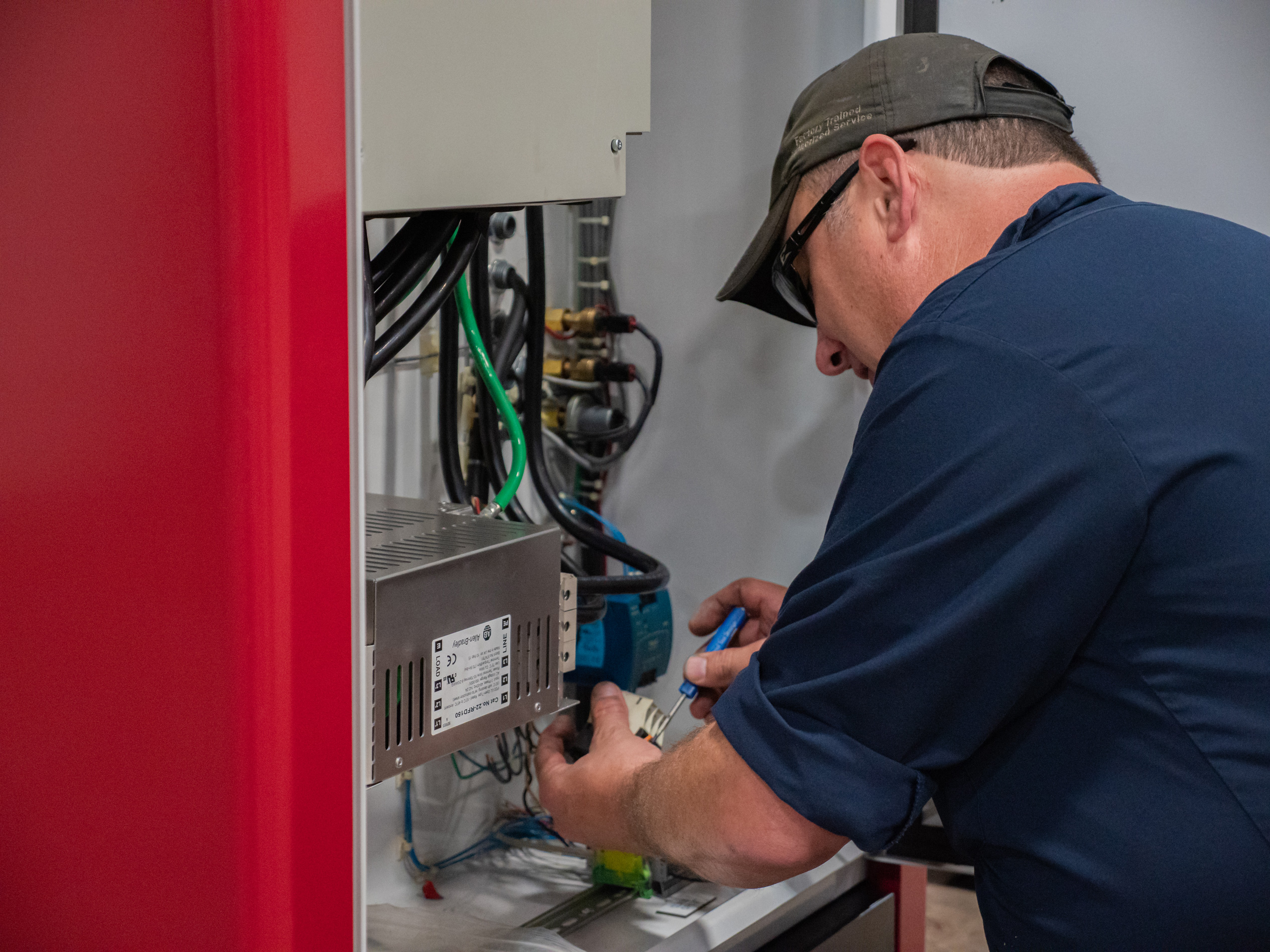 Energy technician servicing industrial machine