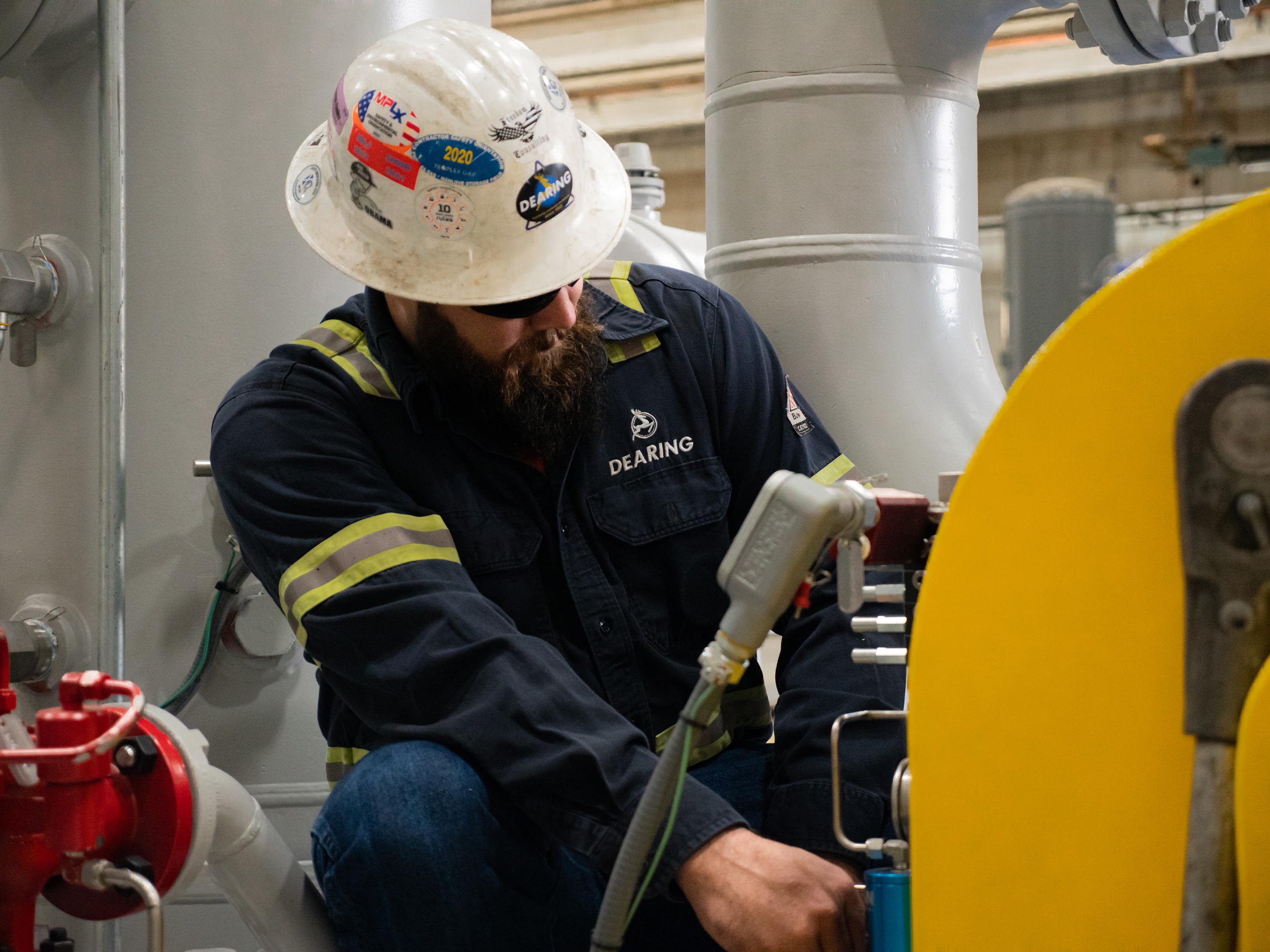 Dearing employee checking performance of industrial machinery