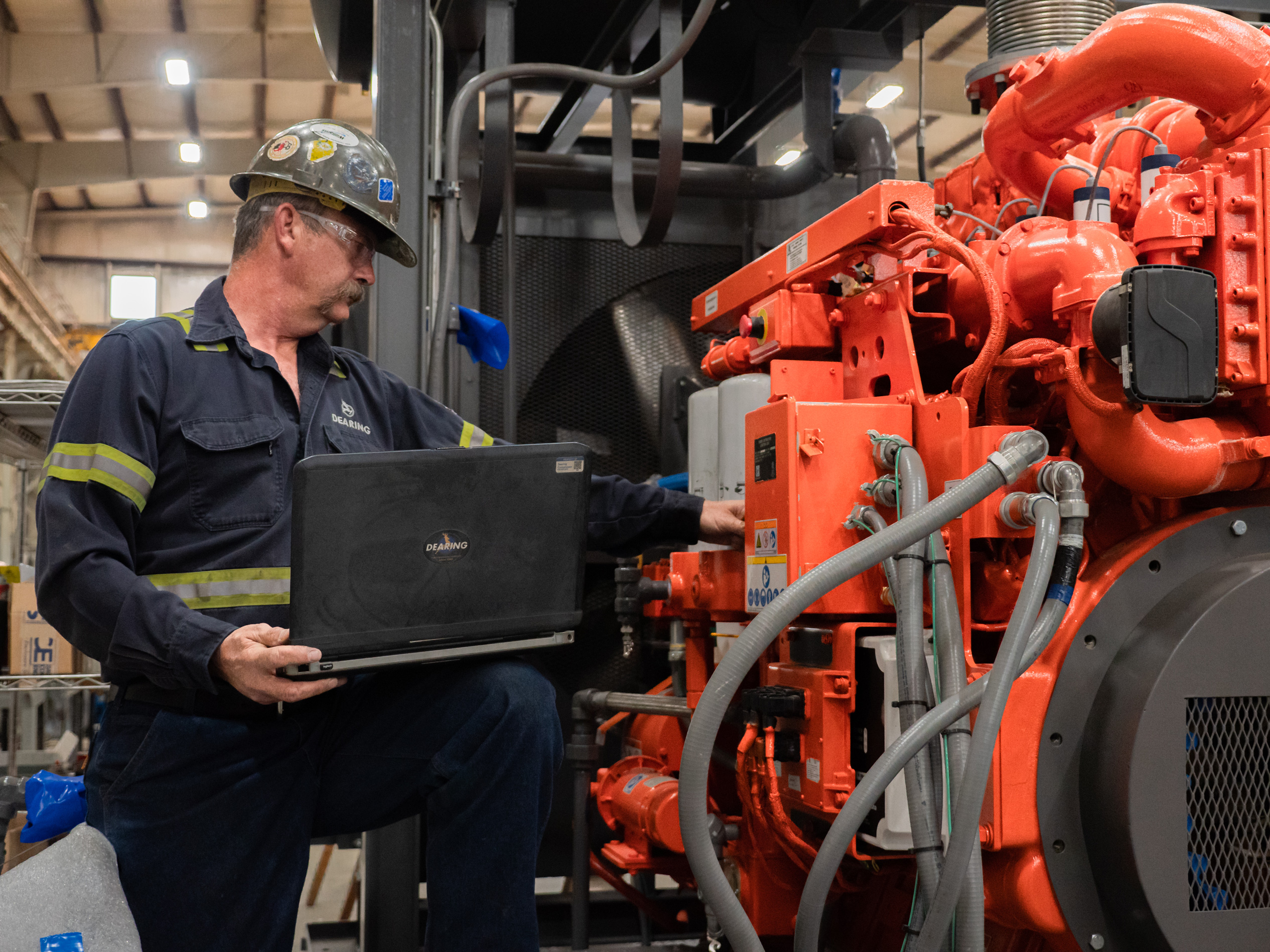 Dearing energy service technician analyzing machine