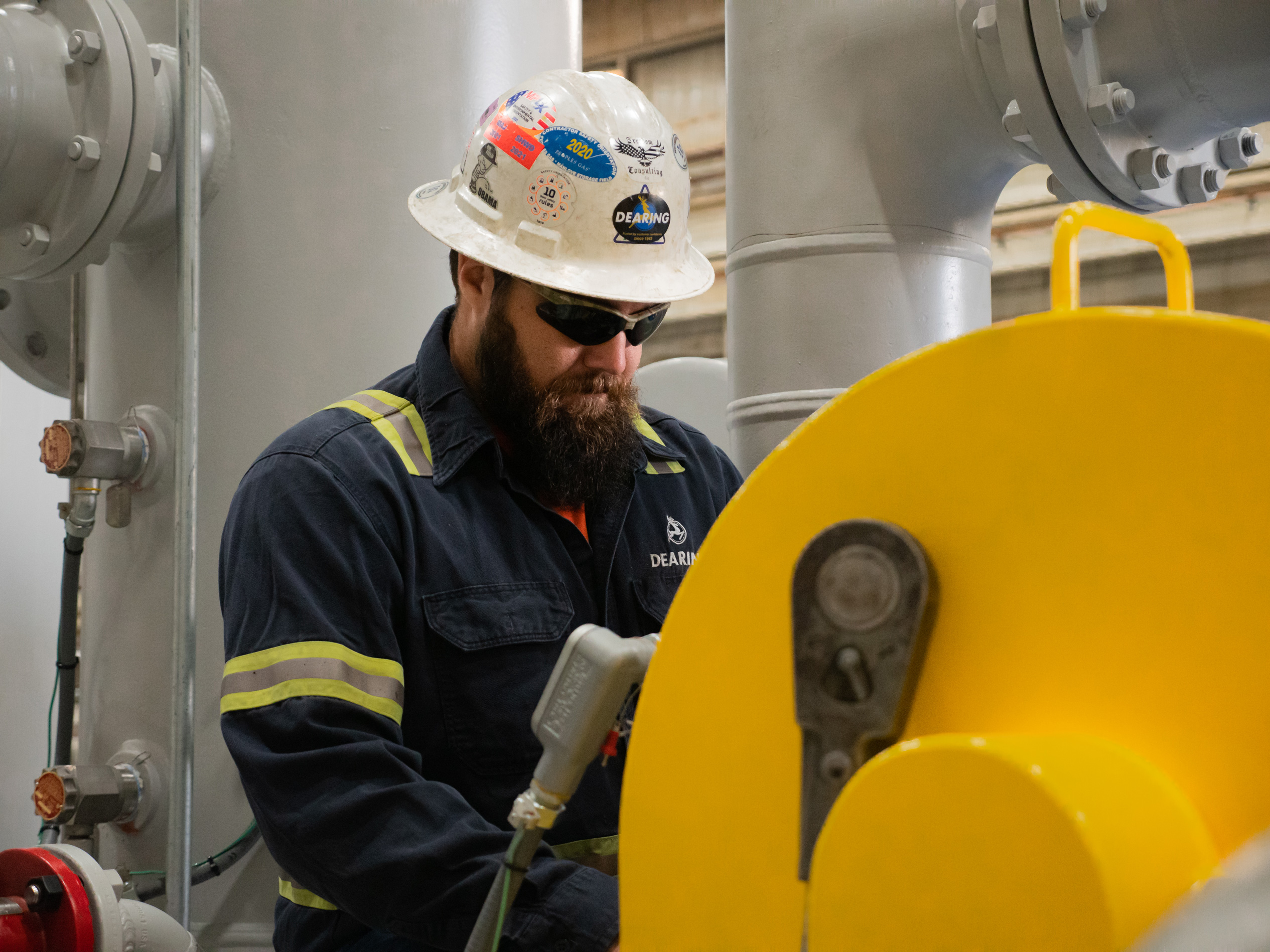 Dearing employee checking performance of energy service machinery