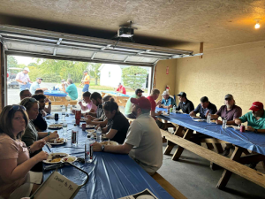 Employees and guests sharing a meal during Dearing’s annual golf outing