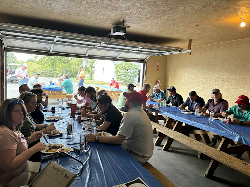 Employees and guests sharing a meal during Dearing’s annual golf outing