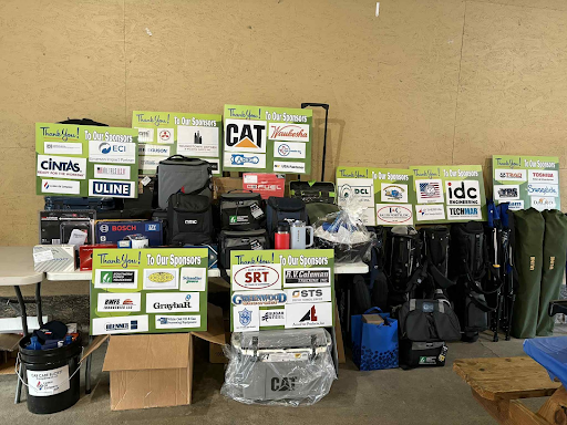 Sponsor recognition signs and prize table set up for Dearing’s annual golf outing.