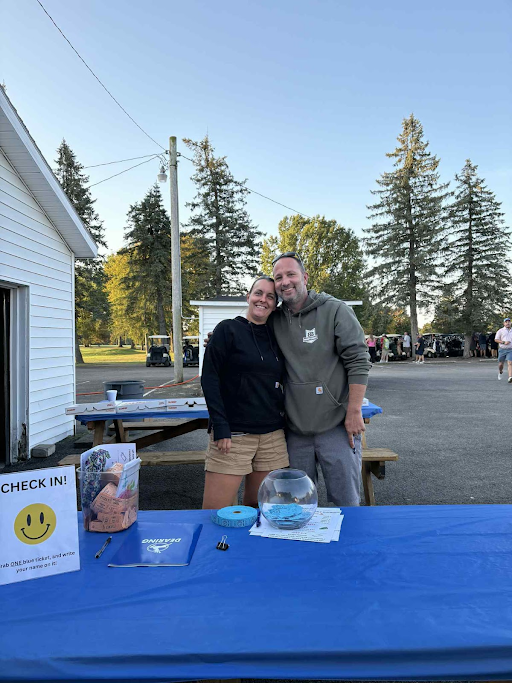 Volunteers greeting guests at the check-in table for Dearing’s annual golf outing.